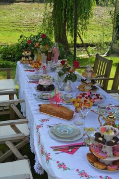 a long table covered with plates and cakes