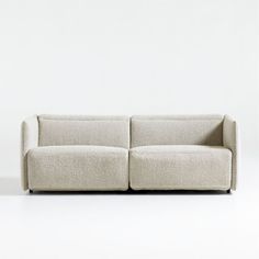 a white couch sitting on top of a white floor