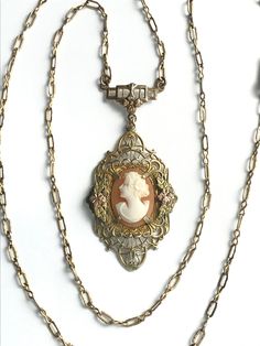 "Details, details on this exquisite cameo necklace! From the intricate chain to the multi colored gold and dimensional filigree mount. Rose and green gold flowers on each side of the cameo add brightness and depth. The cameo itself is sublime. This expertly carved left facing woman has a becoming upward gaze. Look closely at her lovely, neckline, face and hair. A little about the symbolism on this unique antique jewelry piece:  The rose gold orange blossoms are symbols of innocence, purity, eter Vintage Cameo Jewelry, Gulfport Ms, Cameo Pendant Necklace, Wife Jewelry, Orange Blossoms, Cameo Jewelry, Vintage Cameo, Gold And Silver Rings, Cameo Necklace