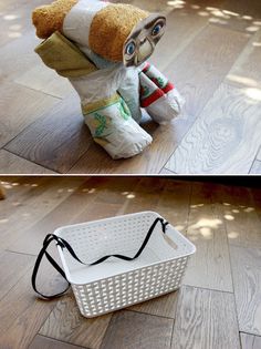 a stuffed animal sitting on the floor next to a basket