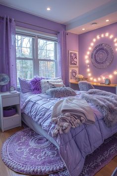 a bedroom decorated in purple and white with lights on the wall above the bed, along with a round rug