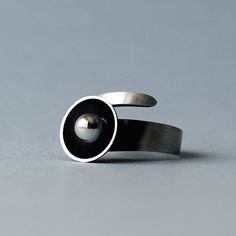 SIMPLE collection was created for women who appreciate the simple and subtle form. This modern and minimalistic ring was made from oxidised sterling silver. It has modern, contemporary, organic form and unique character. Ideal for women who prefer a modest jewelry. Best in set with earrings or pendant. Diameter: 14 mm Silver ball: 6 mm Ring is adjustable, but please tell me your ring size during order. Enjoy colorful world of Shambala A few words about our works: All of the products in gallery a Modern Hand Forged Open Ring, Modern Rings With Oxidized Finish For Gifts, Modern Hand-forged Open Band Ring, Modern Hand Forged Open Band Ring, Minimalist Hand Forged Black Rings, Hand Forged Minimalist Metal Rings, Minimalist Hand Forged Metal Rings, Modern Sterling Silver Rings With Oxidized Finish, Modern Metal Rings With Oxidized Finish