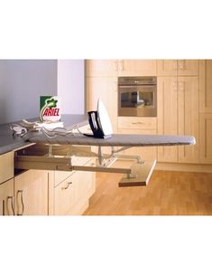 an ironing board sitting on top of a kitchen counter