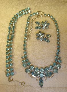 Lovely Vintage EISENBERG ICE Clear & Sparkling Light Blue Rhinestone Parure A Great Fashion Accessory & Gift Item! This is a very beautiful EISENBERG ICE light blue and clear prong set rhinestone parure and it is in very good vintage condition. All rhinestones are present and shining. The rhodium back of each piece is signed with the Eisenberg Ice logo. The necklace measures about 13" long with a 3 1/2" extension.The bracelet measures approximately 7" long and the earrings are 1 1/4" by 1". This 3 piece set probably dates from the 1950's to 60's.     Please view the photos before bidding. This parure is sold "as is". If you are interested in other items, please visit our eBay store at https://stores.ebay.com/thecosartistart. We are always adding to our inventory. Thank you for viewing our Ice Logo, Vintage Jewelry Antique, Antique Costume Jewelry, Vintage Cameo, Vintage Antique Jewelry, Brooch Jewelry, Old Jewelry, Blue Rhinestones, Vintage Rhinestone