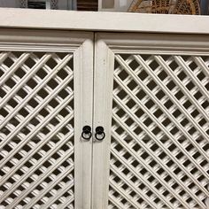 a white cabinet with two black handles on it