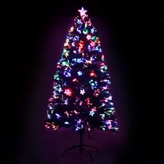 a brightly lit christmas tree in the dark