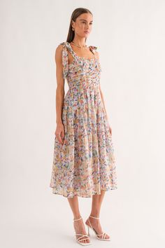 The Mona Floral Corset Midi Dress showcases stunning blue blooms and adjustable tie straps for a charming look. This midi dress features a corset style, sweetheart neckline, and chic ruched detailing in lightweight chiffon. It's perfect for adding a touch of femininity and brightening up your summer wardrobe. With its bright floral print, it's sure to turn heads and make a statement. Late Bloomer, Corset Midi Dress, Midi Dress Blue, Floral Corset, Summer Wedding Outfits, Corset Style, Blue Midi Dress, Look Your Best, Floral Midi Dress