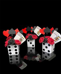 four dices with roses and playing cards on them sitting in front of each other