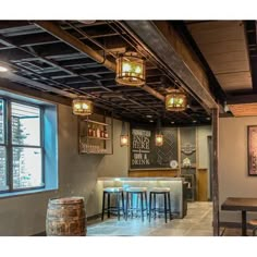 the inside of a restaurant with several stools and lights hanging from the ceiling above