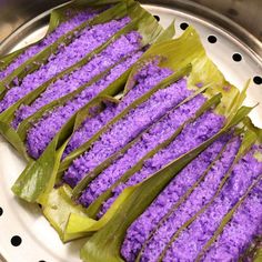 some purple food is sitting on a silver plate