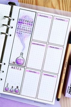 an open planner with the words october written on it next to a pen and marker