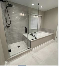 a bathroom with a walk in shower next to a bath tub