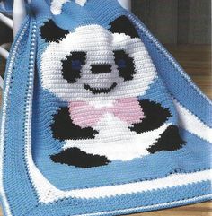 a crocheted blanket with a panda bear on it