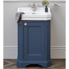 a bathroom sink with a blue cabinet underneath it