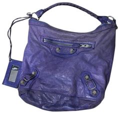 The Balenciaga Giant Classic Day Bag Is Perfect For Every Day Reuse. Crafted From Leather In A Deep Purple, The Bag Has A Classy Silhouette With A Top Handle And Signature Accents In Silver Town Hardware Adorning The Front. The Zipper Opens Up To A Fabric Lined Interior. Measurements Approximately: Shoulder Strap Drop 8 Inches; Height 13 Inches; With 14 Inches; Depth 3 Inches This Bad Comes With A Mirror That Is Attached. Luxury Purple Bags With Palladium Hardware, Designer Rectangular Hobo Bag With Silver-tone Hardware, Designer Hobo Bag With Silver-tone Hardware For Shopping, Designer Purple Shoulder Bag With Detachable Handle, Designer Hobo Bag With Silver-tone Hardware, Purple Bags With Silver-tone Hardware For Shopping, Luxury Purple Shoulder Bag With Silver-tone Hardware, Designer Purple Double Handle Shoulder Bag, Designer Purple Shoulder Bag For Everyday