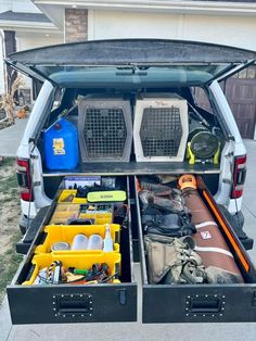 the back end of a truck with its trunk open and various items packed in it