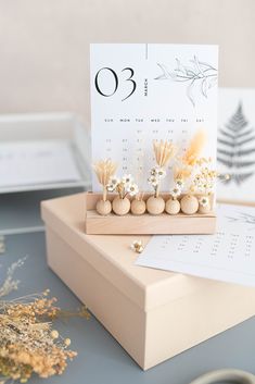 a table with a calendar and some flowers on it