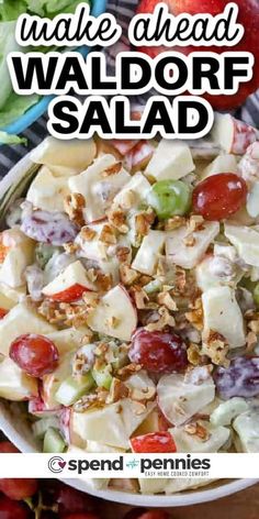 a salad with apples, grapes and walnuts in a white bowl on top of a table