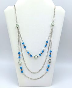 "Add that stylish glow to any look with this stunning necklace.  Crackled blue and crystal glass beads makes this necklace shimmer beautifully in the sunlight.  A worthy addition to any jewelry collection.  It makes a lovely gift for friends or family and is a wonderful way to treat yourself to something new. Necklace Length Measures: 28\" and is a silver curb chain with a lobster claw clasp    (Please measure before ordering.  Everyone has a different chest and neckline sizes, which affects how Elegant Light Blue Beaded Chain Necklaces, Elegant Light Blue Beaded Chain Necklace, Blue Crystal Beaded Necklaces For Jewelry Making, Elegant Light Blue Necklace With Beaded Chain, Blue Crystal Necklaces With Round Glass Beads, Blue Glass Beaded Chain Jewelry, Blue Glass Crystal Necklace With Round Beads, Blue Round Beaded Glass Crystal Necklace, Blue Crystal Necklaces With Colorful Beads