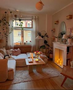 a living room filled with furniture and a fire place in front of a large window