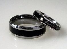 two black and white wedding bands with the words love written on them