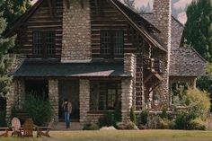 a painting of a log cabin with two adiron chairs