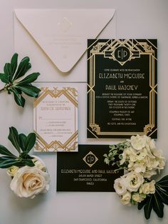 the wedding stationery was done in black and gold, with white flowers and greenery