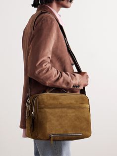 a man with dreadlocks holding a brown bag