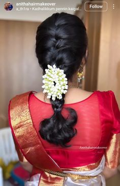 the back of a woman's head with flowers in her hair