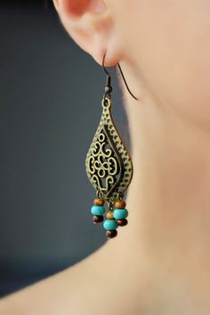 "These unique boho earrings was made of big drop shape antique brass charms, tiny czech glass \"picasso\" style blue,brown beads and antiqie brass earring hooks. Earring hooks are from nickel free and lead free metal. A wonderful jewelry for you or an unique gift for someone speacial! *The total lenght of earrings is about 67 mm including earring hooks. Other earrings of my shop you can see here: https://www.etsy.com/shop/NaTavelli?section_id=13757927 Thanks for visit." Bohemian Brass Beaded Drop Earrings, Bohemian Bronze Earrings With Dangling Beads, Bohemian Bronze Jewelry With Dangling Beads, Bohemian Brass Beaded Earrings, Bohemian Brown Beaded Brass Earrings, Bohemian Antique Gold Copper Earrings, Bohemian Bronze Beaded Earrings Nickel Free, Bohemian Bronze Beaded Nickel-free Earrings, Bohemian Teardrop Chandelier Earrings For Pierced Ears