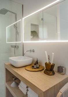 a bathroom with a sink, mirror and soap dispenser on the counter