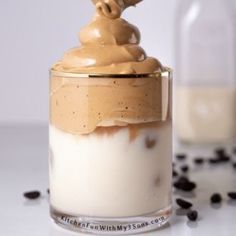 a glass jar filled with pudding and topped with whipped cream, chocolate chips on the side