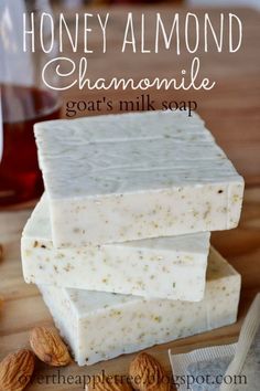 three soap bars stacked on top of each other with almonds next to it and the words honey almond chamole goat's milk soap