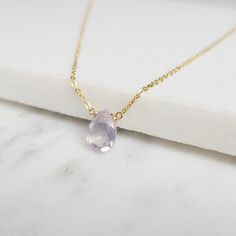 Add a touch of elegance with this handmade necklace, featuring a natural Lavender Quartz gemstone dangling in a handmade frame on a simple dainty chain. Choose your length for a choice to wear it as a choker or a long layered necklace. Simple, minimal, and elegant all-in-one necklace. Makes a great gift to add to any gemstone lover's collection. Perfect to gift for Christmas, Valentine's Day, Mother's Day, and more! Gemstone: Lavender Quartz, Scorolite Gemstone Size: 10.0 mm Gemstone Shape: Pan, Elegant Dangle Drop Necklace With Natural Stones, Elegant Purple Necklace With Delicate Chain, Elegant Lavender Drop Necklaces, Elegant Drop Necklace With Natural Stones And Teardrop Pendant, Dainty Teardrop Pendant Necklace With Natural Stones, Elegant Drop Necklace With Briolette Natural Stones, Handmade Elegant Drop Crystal Necklaces, Elegant Amethyst Dangle Necklaces, Elegant Briolette Drop Necklace With Natural Stones