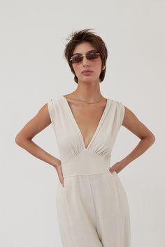 The habana jumpsuit a stunning ensemble that effortlessly combines comfort and elegance. this jumpsuit features a charming knot in the back adding a touch of sophistication to your fashion repertoire. Elegant V-neck Jumpsuit For Beach, Chic One-piece Jumpsuits And Rompers For Loungewear, Chic Beige Jumpsuits And Rompers For Beach, Elegant V-neck Jumpsuits And Rompers For Summer, Chic Beige Jumpsuit For The Beach, Chic Loungewear Jumpsuits And Rompers, Elegant Vacation Jumpsuits And Rompers With V-neck, Elegant V-neck Jumpsuits And Rompers For Vacation, Elegant V-neck Jumpsuit For Vacation