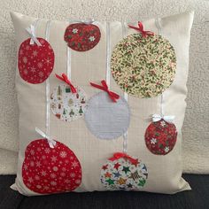 a pillow with christmas ornaments hanging from it