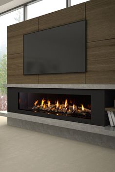 a modern fireplace in a living room with large windows and a flat screen tv on the wall