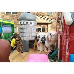 two children playing in an inflatable play area