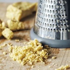 a grater and some food on a wooden table