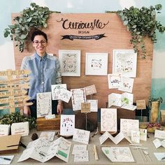 a woman standing in front of a table covered with cards and papers that say curasio