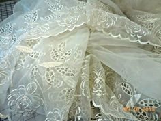 an image of white lace on fabric