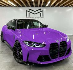 a purple sports car is parked in a showroom