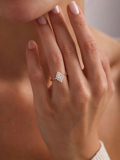 a woman's hand with a diamond ring on it