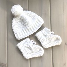 "Size 3 to 6 months. This is a little baby hat and booties set, crocheted in white in a thicker weight acrylic yarn. The hat will fit up to a 18\" (46 cms) head circumference, and is 6\" (15 cms) in depth from crown. The sole of the booties measures 4\" (10 cms). Machine wash and dry, short gentle cycle, low heat, or hand wash and dry flat. Please read my policies and FAQ for more information. To view more of my items ....   lurayknitwear.etsy.com Shipping will be combined for multiple items wit Cute White Baptism Hat, White Winter Booties As A Gift, White Booties As Winter Gift, White Winter Booties As Gift, Warm White Winter Booties, White Crochet Hat For Winter Gift, Cute White Crochet Hat For Gifts, Cute White Crochet Hat For Gift, Cute White Crochet Hat As Gift