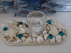 there is a tray with shells and pearls on it