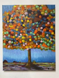 an abstract painting of a tree with multicolored circles on it's trunk