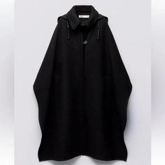 Cape Made With 75% Wool. Hood With Strap And Button. Front Pockets. Front Button Closure. Black Black Wool Hooded Outerwear, Black Wool Cape For Workwear, Hooded Black Cape For Fall, Zara Black Hooded Outerwear, Black Hooded Cape For Fall, Casual Black Hooded Cape, Black Hooded Outerwear With Buttons, Zara Cape Coat, White Cape Blazer