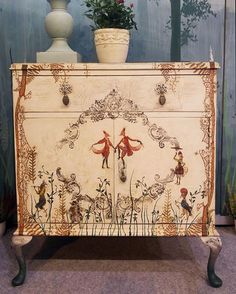 an old dresser has been decorated with flowers and birds