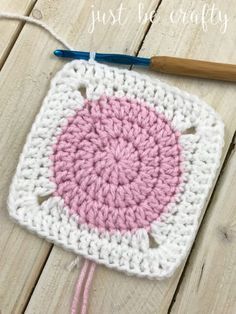 a crocheted square with the words just be crafty written in white and pink