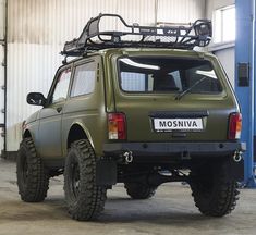 an suv parked in a garage with its roof rack mounted on it's back